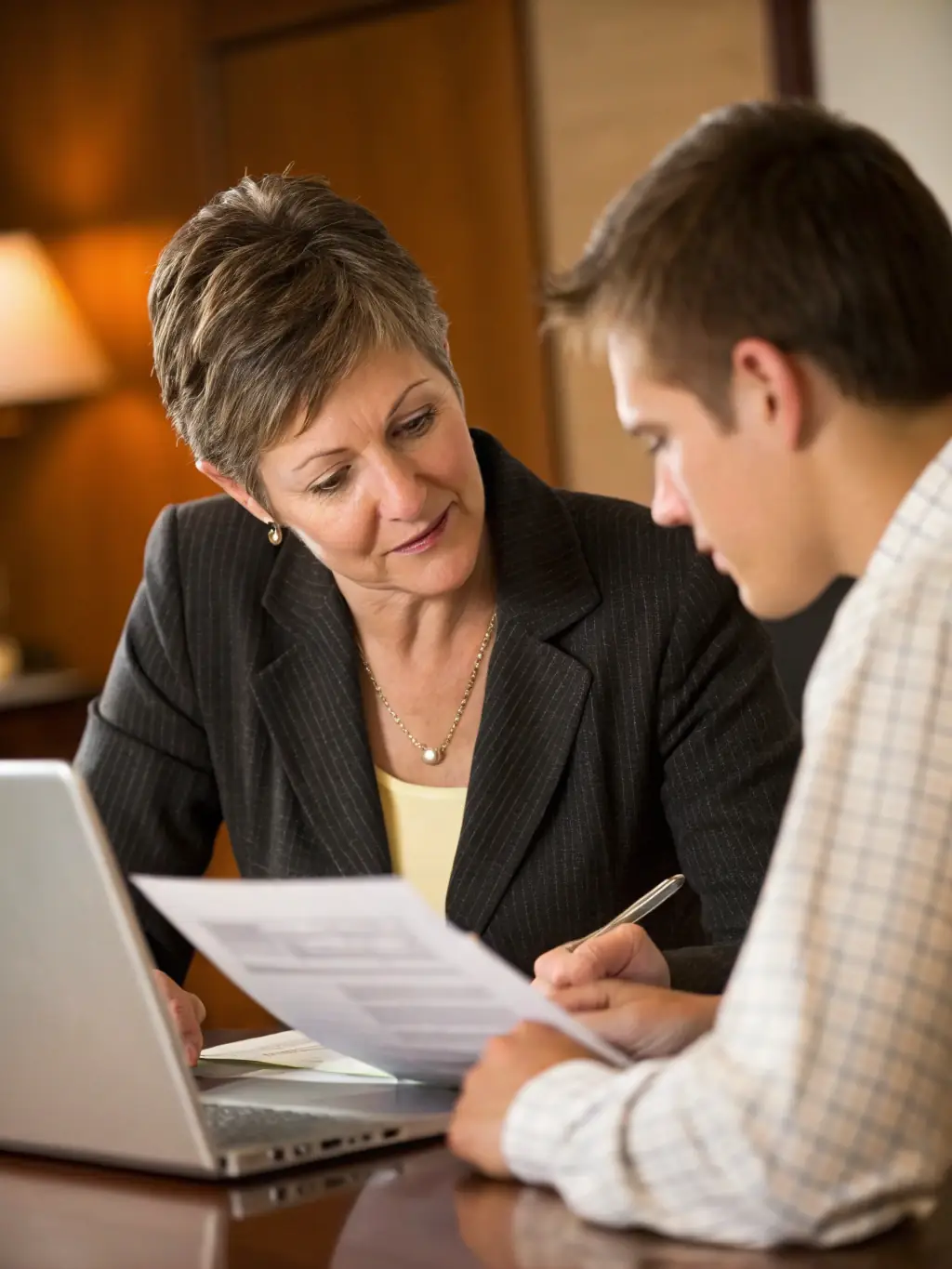 An insurance agent confidently presenting a policy to a client, symbolizing RMA Solutions' deal closing assistance.